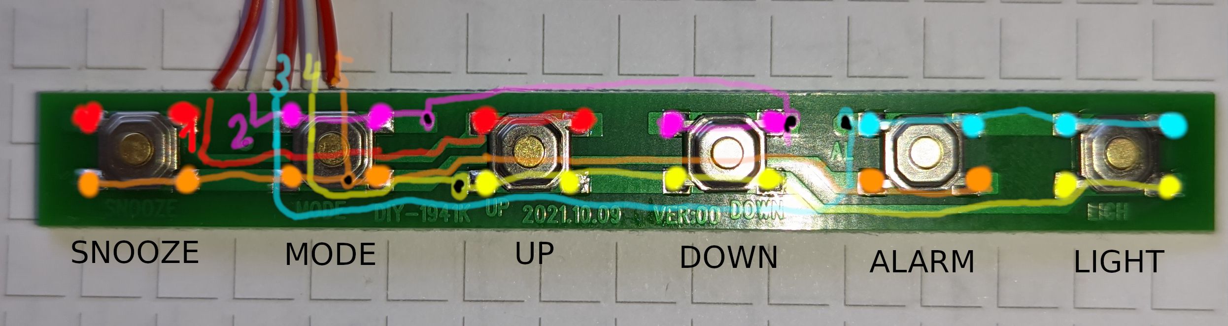 An elongated green PCB with 6 buttons on it