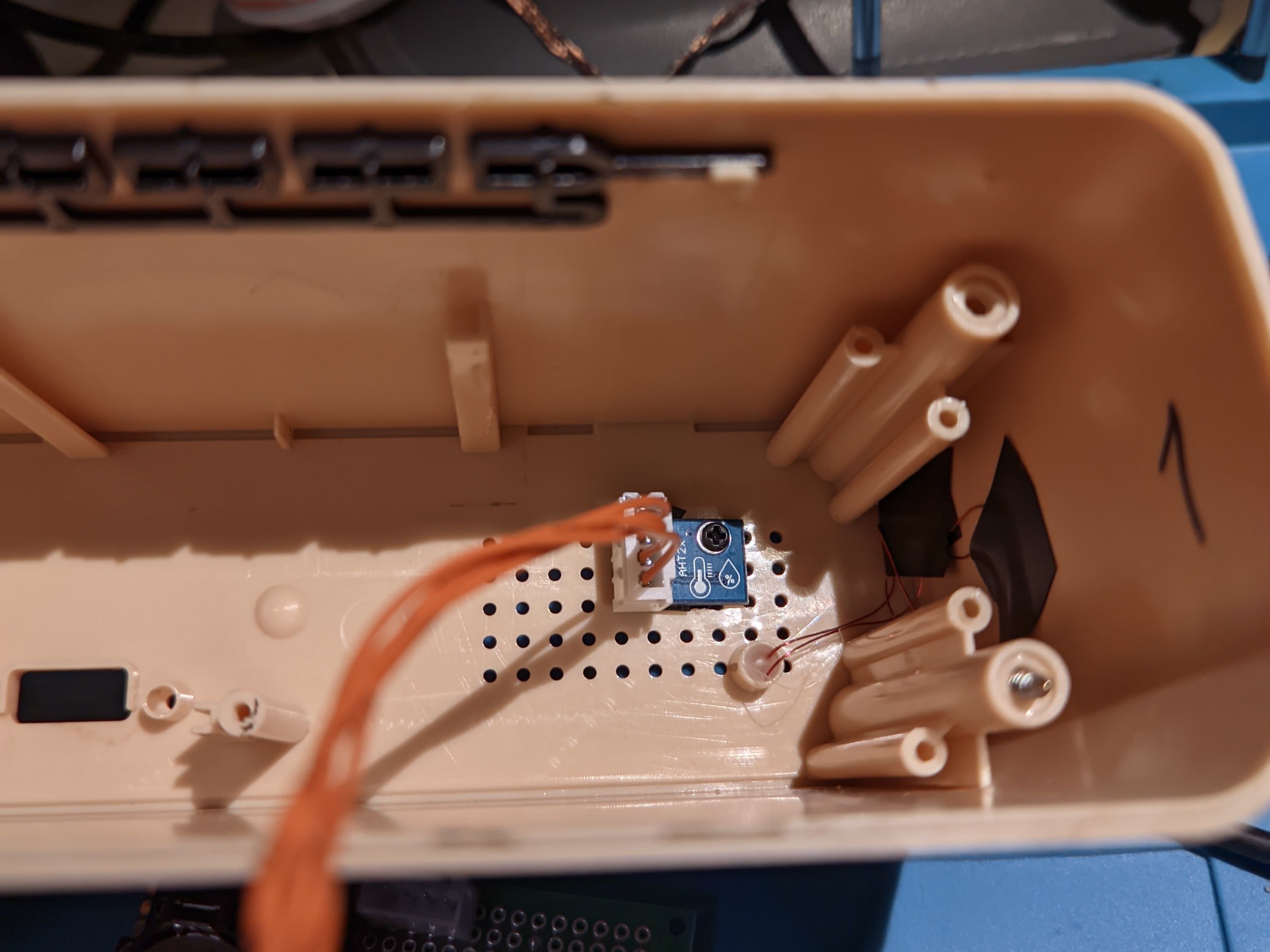 A look inside the opened case with a small blue board attached to the back
