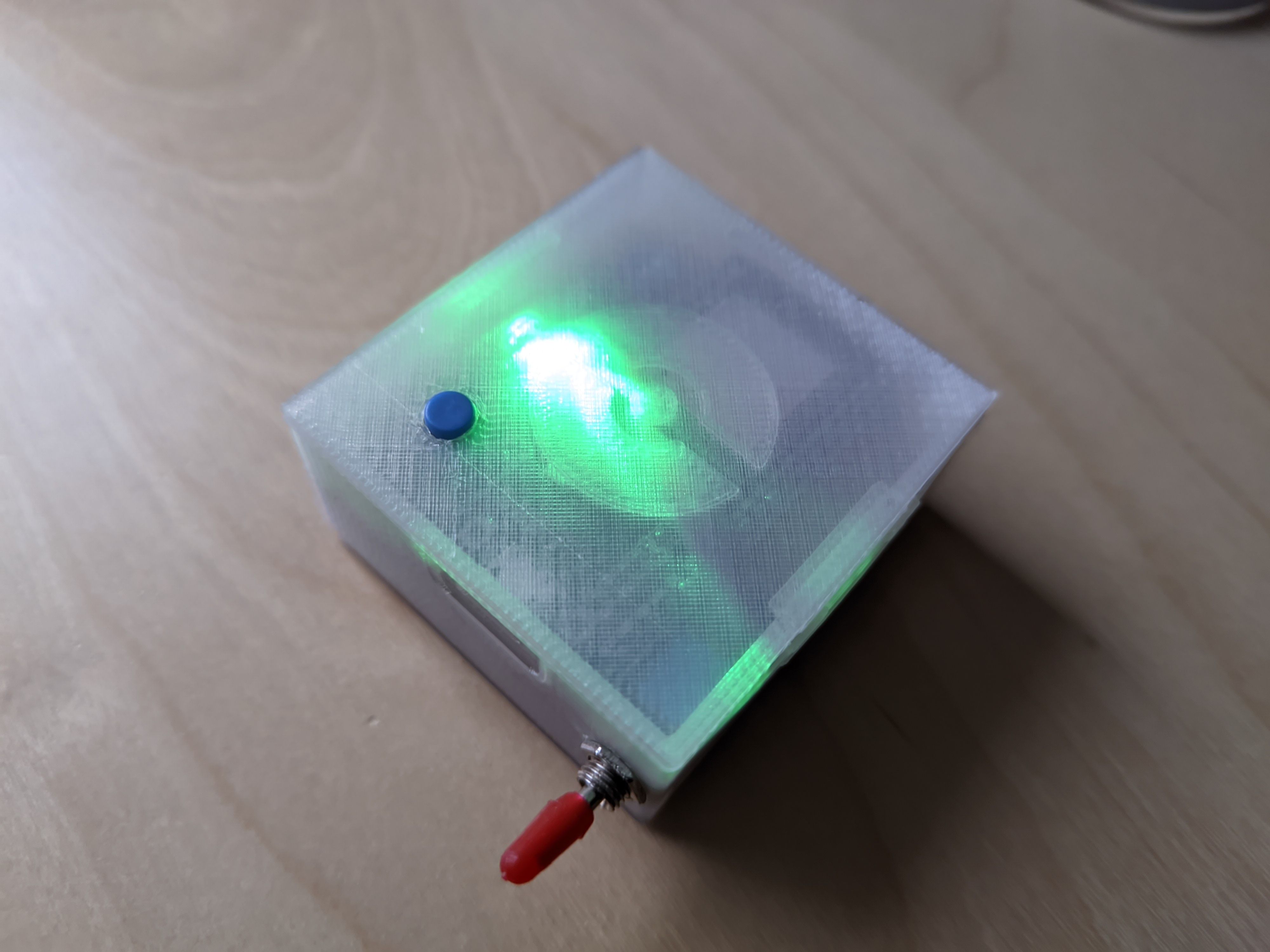 A 3D printed gadget with translucent plastic illuminated with a green LED